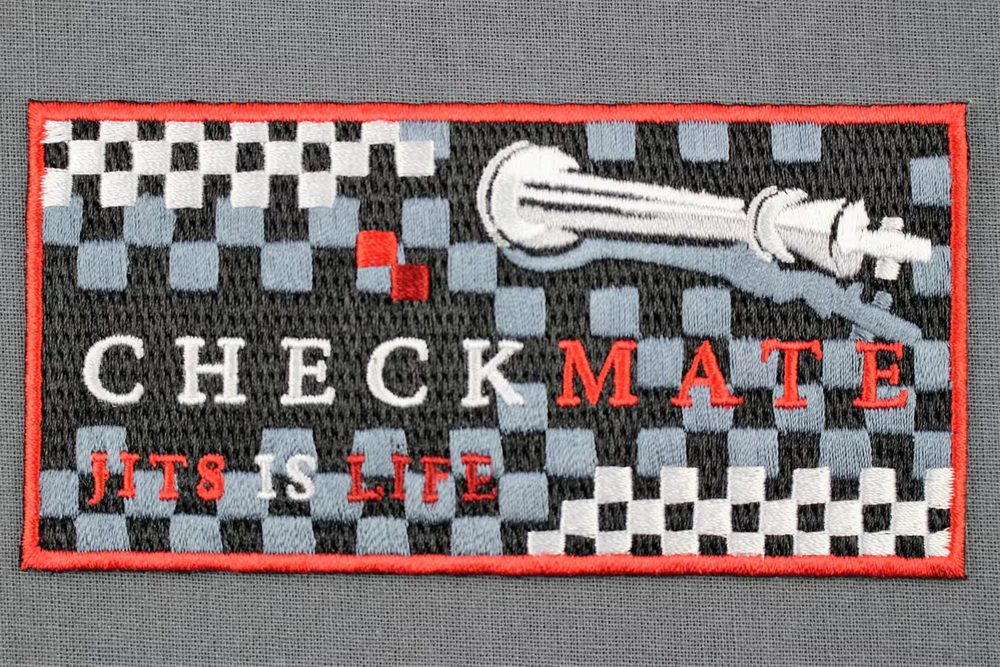 CHECKMATE embroidered patch on a dark gi