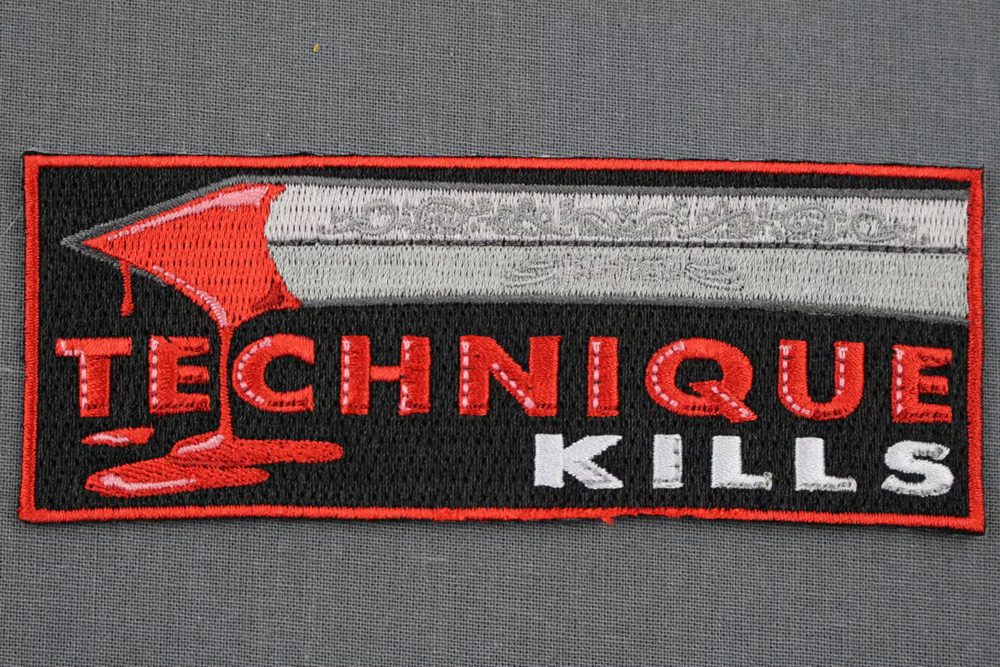 TECHNIQUE Kills embroidered patch on a dark gi